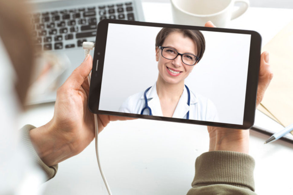 Woman doctor on a video call with a patient.